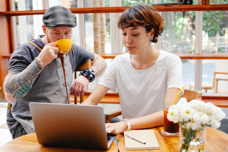 Two business owners looking at laptop