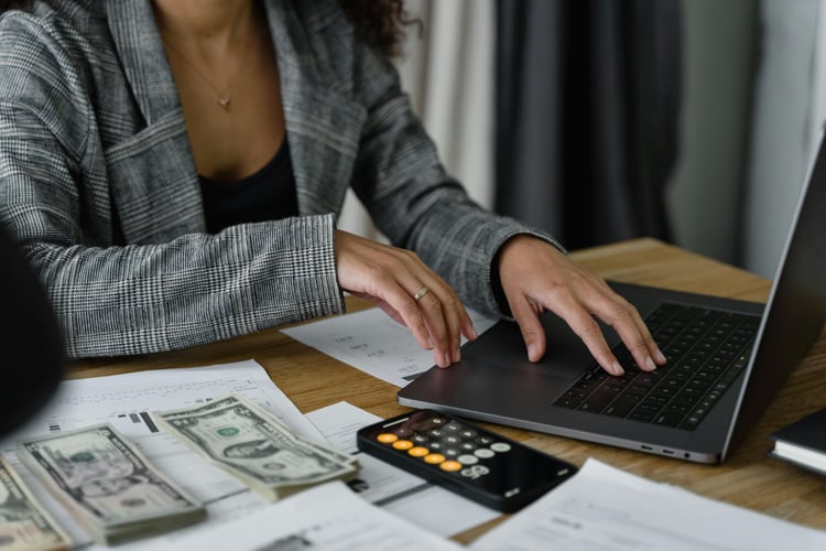 Woman typing with calculator